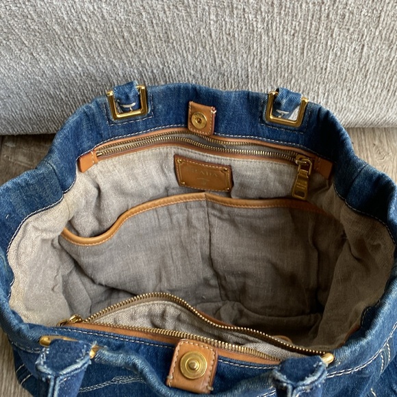 This is a Prada denim tote bag. No rips or tears, just minor wear from use. - Picture 4 of 9